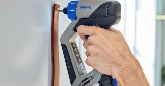 The Dremel Blueprint Multi-Drill being used to attach an object to a wall with a screw.